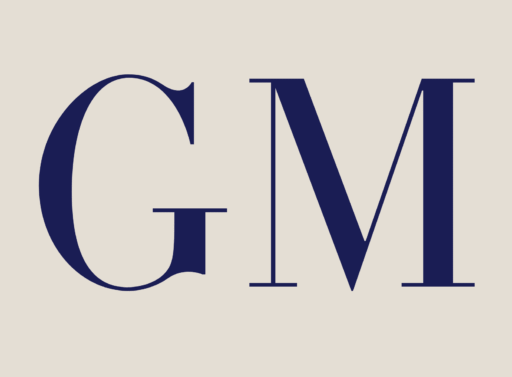 Large, bold, dark blue letters G and M are displayed on a light beige background in a serif font.